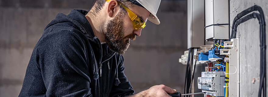 an Instrumentation and Control Technician journeyperson working on some equipment.