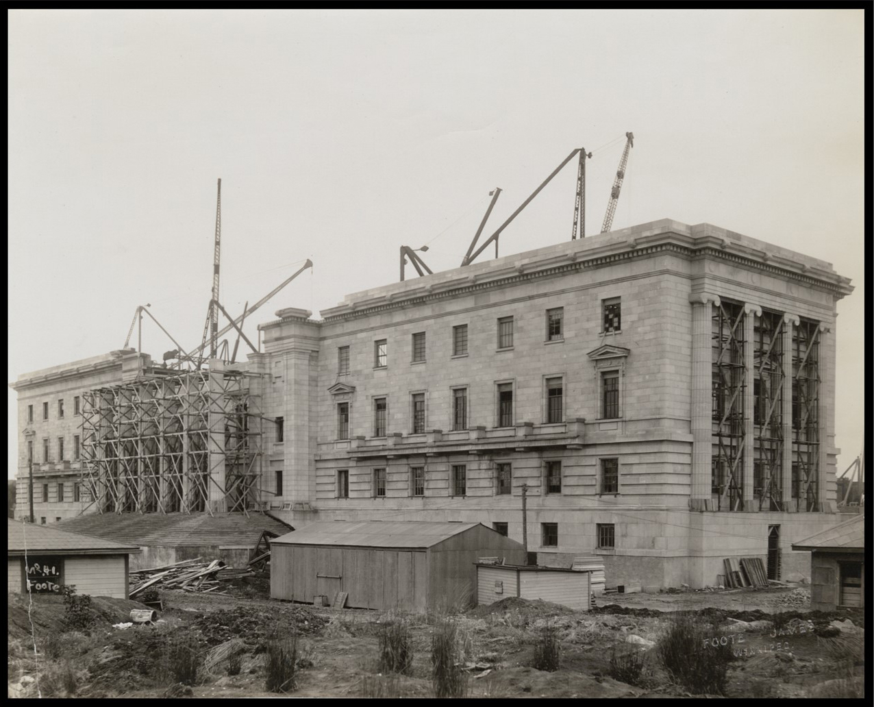 Wide shot of the exterior of the building with most of the walls complete.