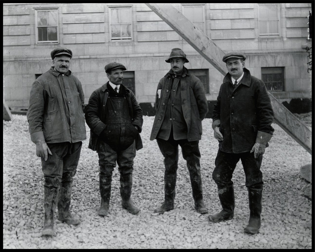 Photo of four smiling men.