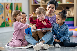 preschool teacher with children playing with colorful-woodentoys at kindergarten