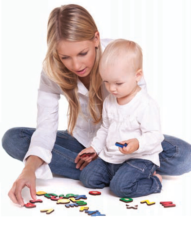 woman and toddler sitting on the floor playing with letters